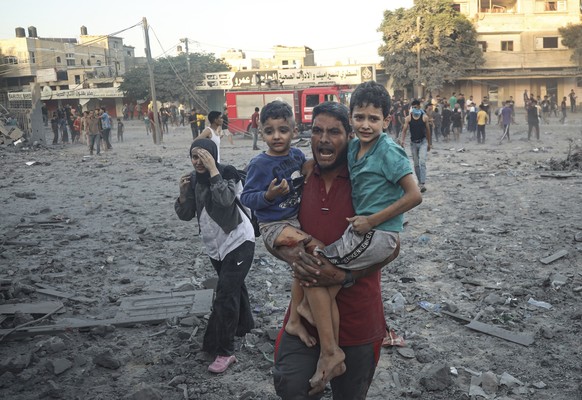 Palestinian walk away after Israeli airstrike in Rafah, Gaza Strip, Tuesday, Nov. 7, 2023. (AP Photo/Eyad Baba)