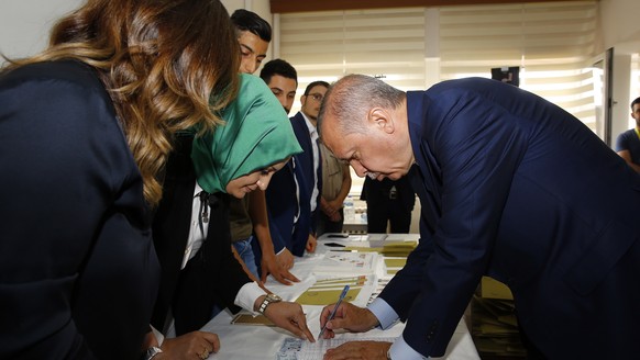 Turkey&#039;s President and Presidential candidate, the leader of Justice and Development Party Recep Tayyip Erdogan, casts his vote at a polling station at Saffet Cebi Middle School in the Uskudar di ...