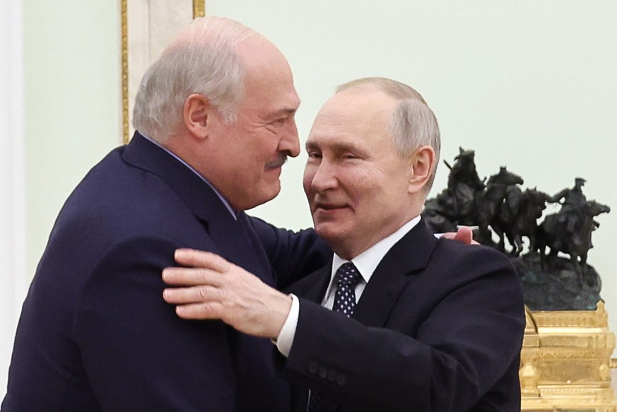 Belarusian President Alexander Lukashenko, left, and Russian President Vladimir Putin embrace each other during their meeting at the Kremlin in Moscow, Russia, Wednesday, April 5, 2023. (Pavel Byrkin, ...