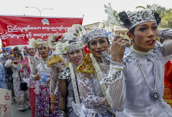 Demonstrators in traditional dancing costumes march against the military coup during a protest in Mandalay, Myanmar on Thursday, Feb. 11, 2021. Large crowds demonstrating against the military takeover ...