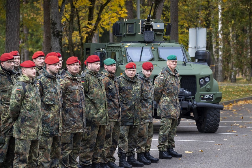 Soldiers of the German Bundeswehr 41st Mechanized Infantry Brigade Forward Command Element wait to greet German Defense Minister Christine Lambrecht upon her arrival at the Rukla military base some 10 ...