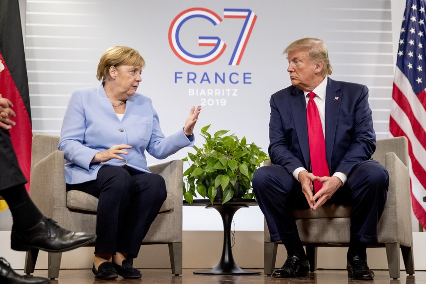 U.S. President Donald Trump and German Chancellor Angela Merkel participate in a bilateral meeting at the G-7 summit in Biarritz, France, Monday, Aug. 26, 2019. (AP Photo/Andrew Harnik)