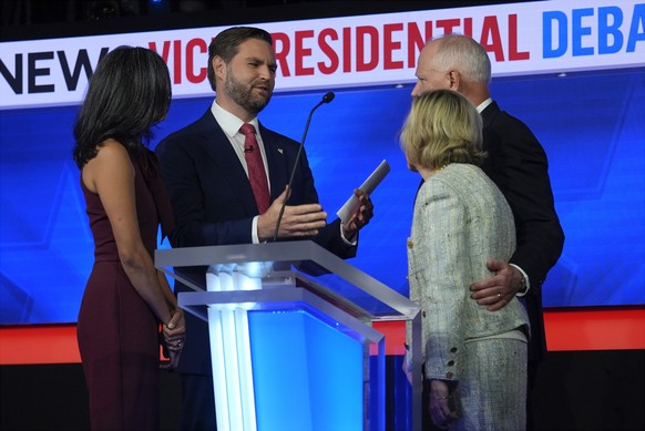 Republican vice presidential nominee Sen. JD Vance, R-Ohio, and his wife Usha Vance talk with Democratic vice presidential candidate Minnesota Gov. Tim Walz and his wife Gwen Walz after the vice presi ...