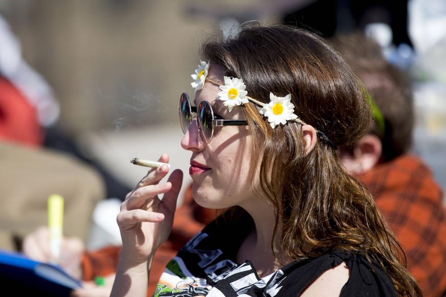 April 20, 2018 - Toronto, ON, Canada - TORONTO, ON - APRIL 20 - Sally Smith smokes marijuana during the 4-20 rally held at Nathan Phillips Square in Toronto on April 20, 2018.. Cannabis activists say  ...