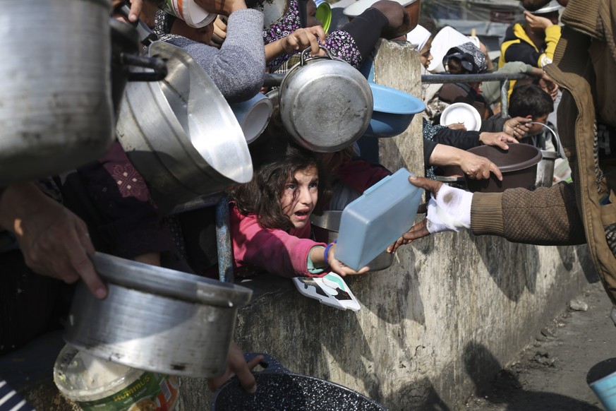FILE - Palestinians line up for free food during the ongoing Israeli air and ground offensive on the Gaza Strip in Rafah, Jan. 9, 2024. A top U.N. official said Friday, May 3, 2024, that hard-hit nort ...