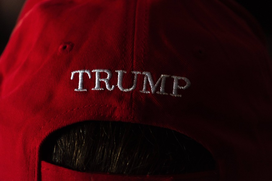 November 6, 2024, Bangkok, Thailand: A supporter of the Republican Party wearing a cap with message Trump seen watching the broadcasting of the U.S. election results at the restaurant in Bangkok. Vote ...