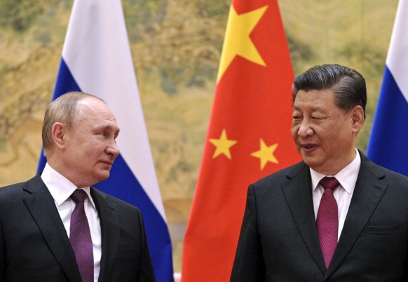 FILE - Chinese President Xi Jinping, right, and Russian President Vladimir Putin talk to each other during their meeting in Beijing, China on Feb. 4, 2022. Just weeks before the Feb. 24, 2022, invasio ...
