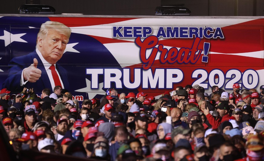 ROME, GEORGIA - NOVEMBER 01: A bus with an image of U.S. President Donald Trump sits next to the crowd during a campaign rally at Richard B. Russell Airport on November 01, 2020 in Rome, Georgia. With ...