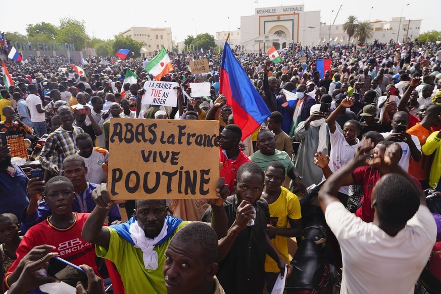 FILE - Nigeriens participate in a march called by supporters of coup leader Gen. Abdourahmane Tchiani in Niamey, Niger, Sunday, July 30, 2023. The French Foreign Ministry says Tuesday, Aug.1, 2023 Fra ...