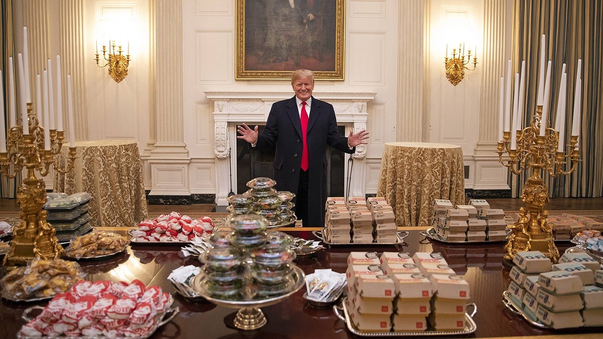January 14, 2019 - Washington, DC, United States of America - U.S President Donald Trump stands behind a spread of fast food that he purchased for the celebration for the 2018 NCAA College Football Na ...