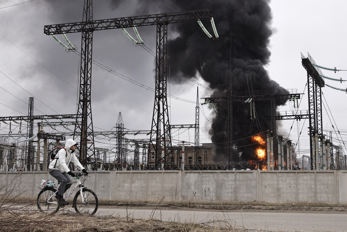 22.03.2024, Ukraine, Charkiw: Ein Mann radelt nach einem russischen Angriff an einem Elektrizitätswerk vorbei. Durch einen der heftigsten Luftangriffe in mehr als zwei Jahren Angriffskrieg hat Russlan ...