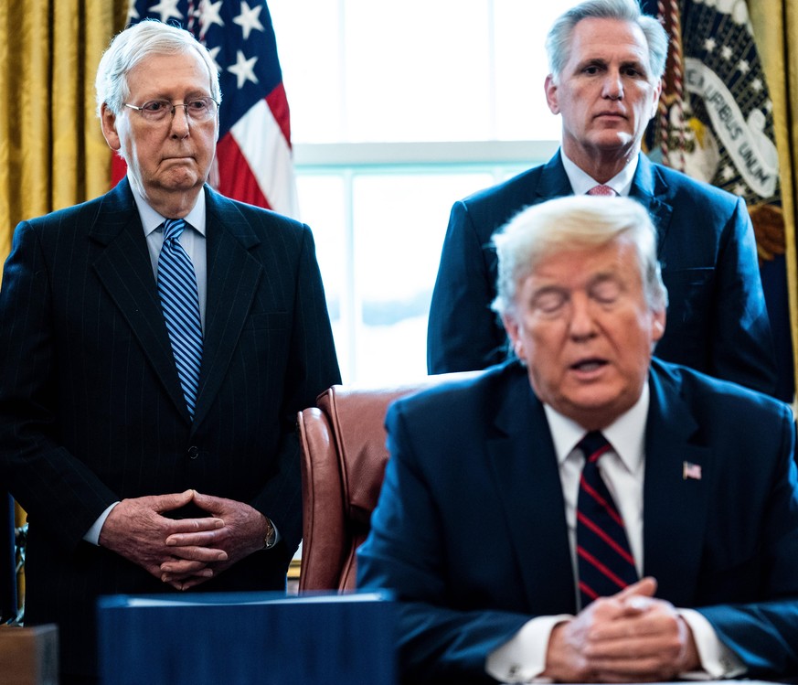 United States President Donald J. Trump participates in a signing ceremony for a two trillion dollar coronavirus relief bill in the Oval Office at the White House in Washington, DC on March 27, 2020.  ...