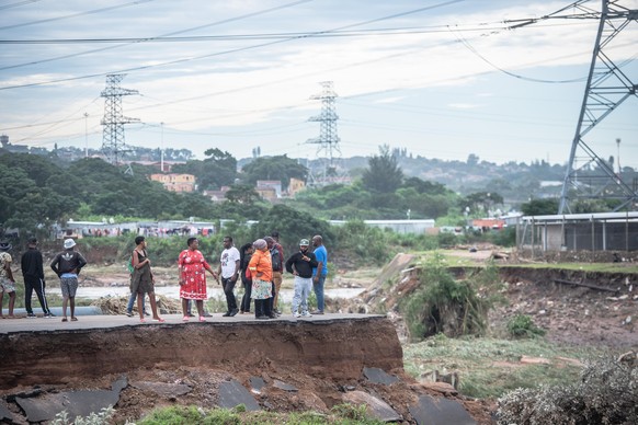 (220413) -- KWAZULU-NATAL, April 13, 2022 (Xinhua) -- People stand on a damaged bridge after heavy rains in KwaZulu-Natal Province, South Africa, on April 13, 2022. The death toll due to heavy rains i ...