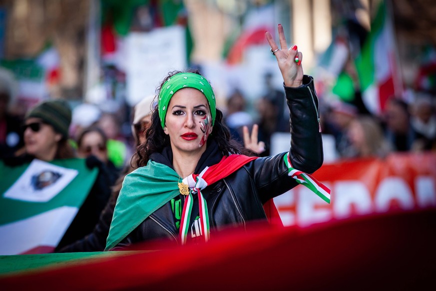 March against the Islamic regime in Iran DC-area protester Roxana Samimi holds two fingers aloft as demonstrators march against the Islamic regime in Iran. Members of the Iranian-American community in ...