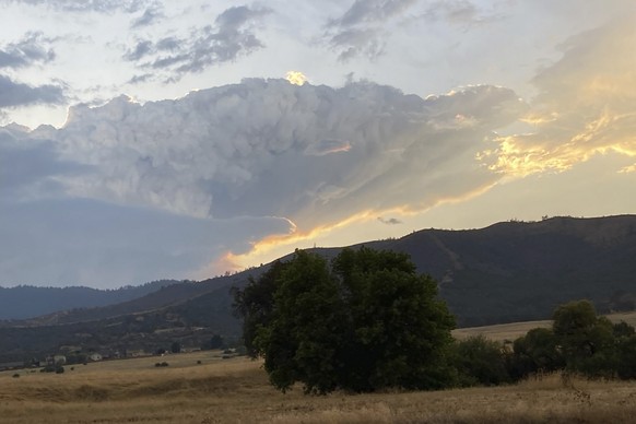 In this photo provided by Caltrans, smoke rises from the Head Fire in Klamath National Forest, Calif., on Tuesday Aug. 15, 2023. A wildfire pushed by gusty winds from a thunderstorm raced through nati ...