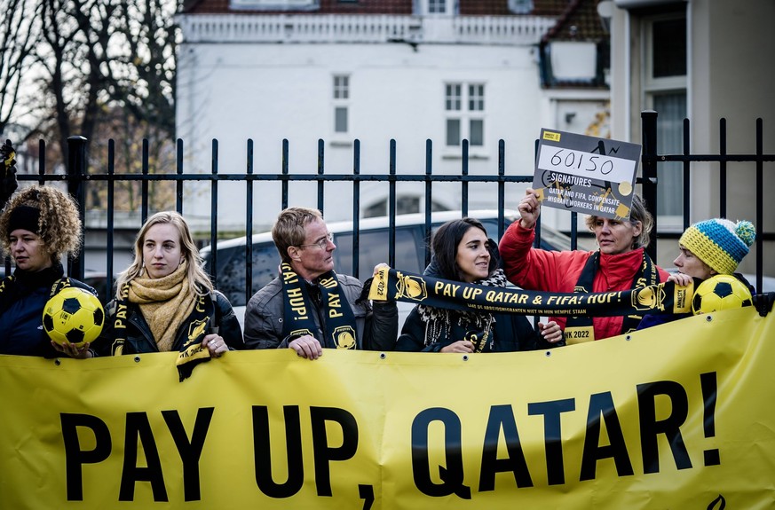 THE HAGUE - Members of Amnesty International prior to offering signatures to the embassy of Qatar. The human rights organization calls on Qatar and FIFA to compensate the affected migrant workers who  ...