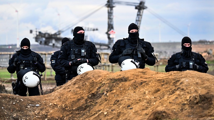 dpatopbilder - 09.01.2023, Nordrhein-Westfalen, Erkelenz: Polizisten sichern das Gelände beim Braunkohletagebau Garzweiler II. Lützerath soll zur Erweiterung des Braunkohletagebaus Garzweiler II abgeb ...