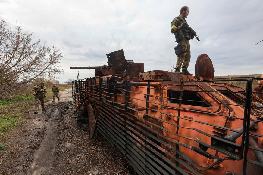 TSUPIVKA, UKRAINE - OCTOBER 25, 2022 - Ukrainian soldiers examine a destroyed Russian military vehicle in Tsupivka village in the north of Kharkiv Region, northeastern Ukraine. Consequences of Russian ...