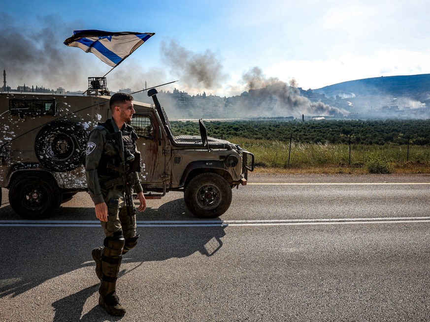 Israeli Riot to West Bank April 13 An Israeli soldier watches over a rising smoke in nearby Duma town near Nablus after it was stormed by Israeli settlers in the Israeli-occupied West Bank on Saturday ...