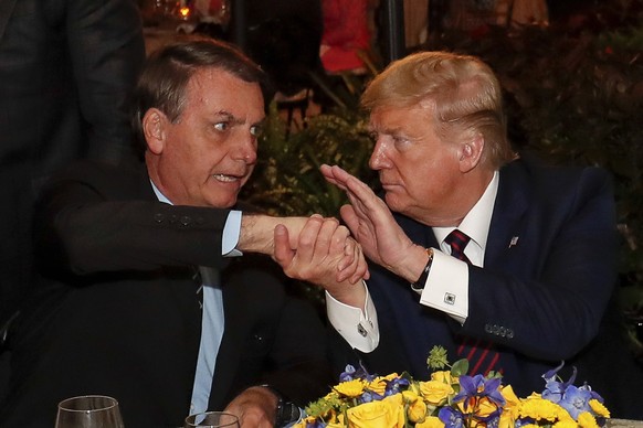 March 7, 2020, Palm Beach, FL, United States: Brazilian President Jair Bolsonaro, left, shakes hands with U.S. President Donald Trump before a dinner at the Mar a Lago resort March 7, 2020 in Palm Bea ...