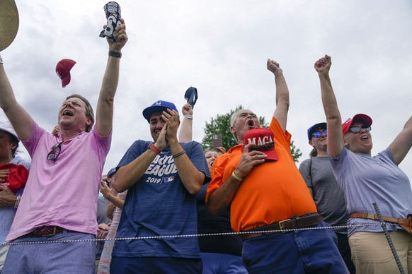 Fans cheer as former President Donald Trump interacts with them during the final round of the Bedminster Invitational LIV Golf tournament in Bedminster, N.J., Sunday, July 31, 2022. (AP Photo/Seth Wen ...