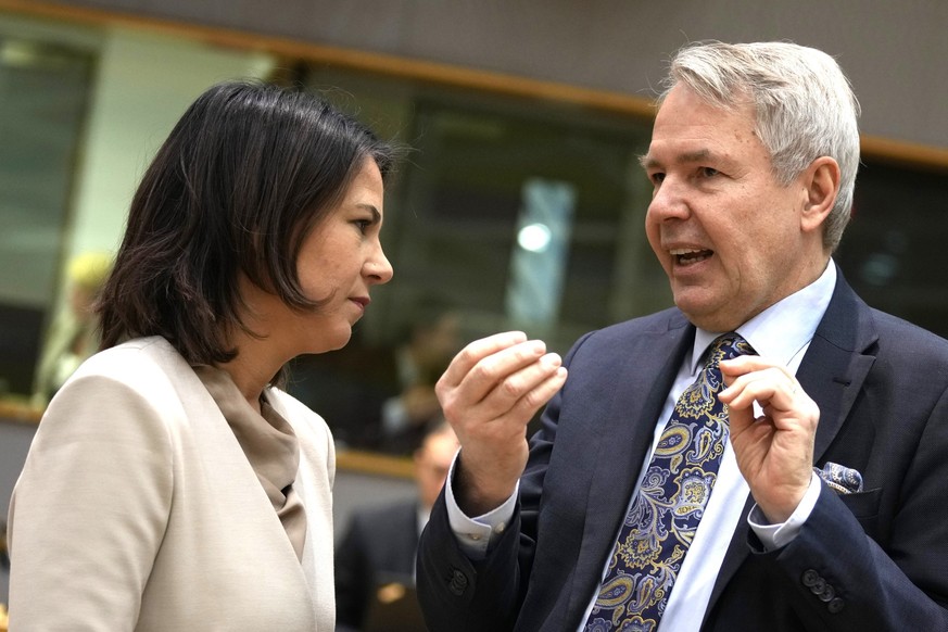 Germany&#039;s Foreign Minister Annalena Baerbock, left, speaks with Finland&#039;s Foreign Minister Pekka Haavisto during a round table meting of EU foreign ministers at the European Council building ...