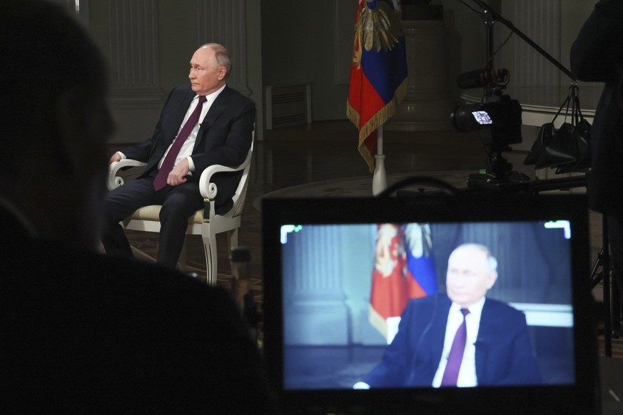 In this photo released by Sputnik news agency on Friday, Feb. 9, 2024, Russian President Vladimir Putin attends an interview with former Fox News host Tucker Carlson at the Kremlin in Moscow, Russia,  ...