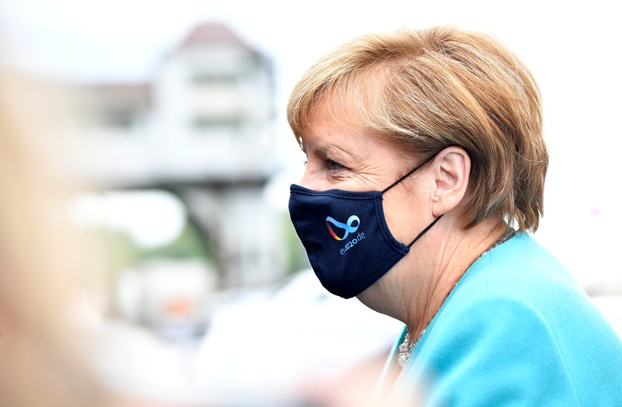 German Chancellor Angela Merkel wears a protective mask as she arrives for a meeting with the leadership of the conservative CDU/CSU parliamentary group, in Berlin, Germany September 2, 2020. Tobias S ...