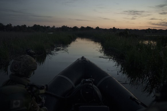 Ukraine Special Operations Forces navigate the Dnipro River before sunrise as they return from a night mission in Kherson region, Ukraine, Saturday, June 10, 2023. (AP Photo/Felipe Dana)