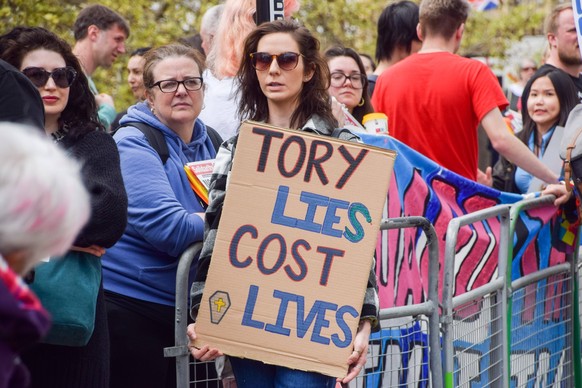 May 1, 2023, London, United Kingdom: A protester holds a Tory lies cost lives placard during the demonstration outside St Thomas Hospital. Demonstrators marched through Westminster in support of the N ...