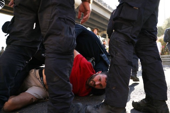 Israeli security forces remove demonstrators during a sit-in blocking the entrance of the Knesset, Israel&#039;s parliament, in Jerusalem on July 24, 2023, amid a months-long wave of protests against  ...