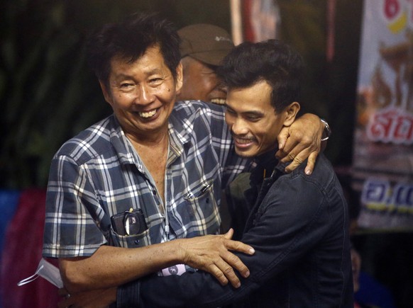 Family members smile after hearing the news that the missing 12 boys and their soccer coach have been found, in Mae Sai, Chiang Rai province, in northern Thailand, Monday, July 2, 2018. A Thai provinc ...