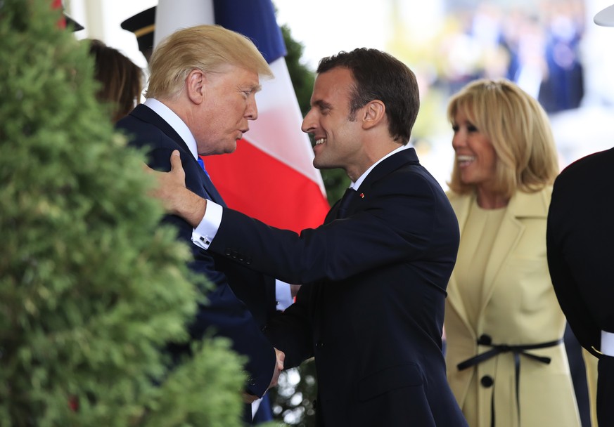President Donald Trump with first lady Melania Trump greet visiting French President Emmanuel Macron and his wife Brigitte Macron upon arrival at the White House in Washington, Monday, April 23, 2018. ...
