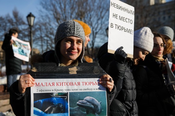 MOSCOW, RUSSIA - FEBRUARY 16, 2019: People take part in a rally in central Moscow to free beluga and orca whales kept in a whale prison off the Russian Pacific coast. A marine containment facility bra ...