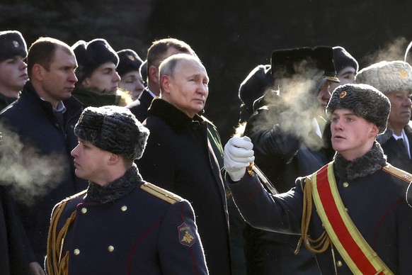 FILE - Russian President Vladimir Putin, center left, attends a wreath-laying ceremony at the Tomb of the Unknown Soldier, near the Kremlin Wall during the national celebrations of the &quot;Defender  ...