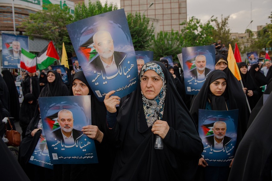 Demonstration in Iran Denouncing the Killing of the Leader of Hamas Iranian women carry pictures of Ismail Haniyeh attending a demonstration denouncing the killing of the leader of Hamas at Palestine  ...