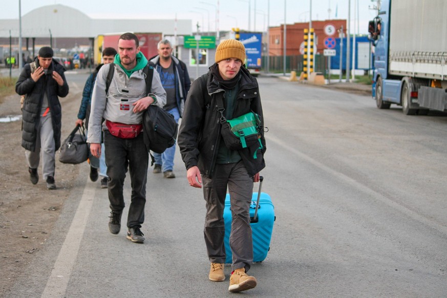 KAZAKHSTAN SEPTEMBER 27, 2022: People are seen at the Syrym automobile crossing point on the Russian-Kazakh border. According to the Kazakh Interior Ministry, around 98 thousand Russian citizens have  ...