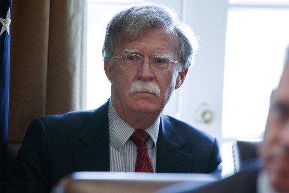 In this April 9, 2018 photo, National security adviser John Bolton listens as President Donald Trump speaks during a cabinet meeting at the White House in Washington. Bolton held talks Thursday with h ...