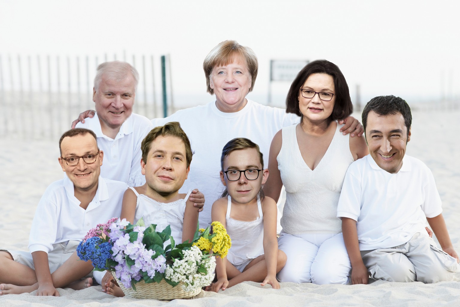 Portrait of a mid adult couple sitting on the beach with their five children