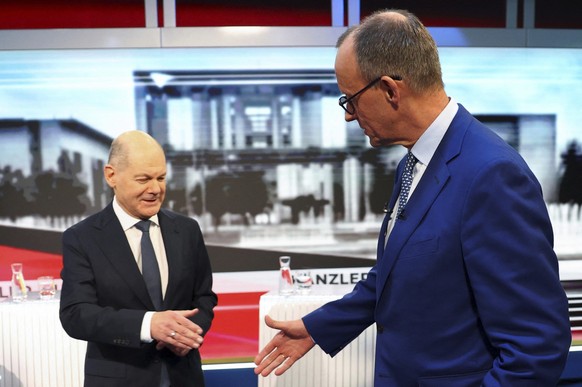 Olaf Scholz, German Chancellor of the Social Democratic Party (SPD), left, and Friedrich Merz, right, leader of the Christian Democratic Union (CDU), are pictured in tv studio ahead of a debate in Ber ...