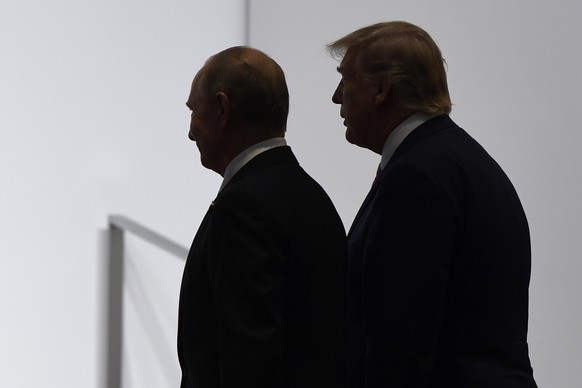FILE - In this June 28, 2019, file photo, President Donald Trump and Russian President Vladimir Putin walk to participate in a group photo at the G20 summit in Osaka, Japan. Russia says it will withdr ...