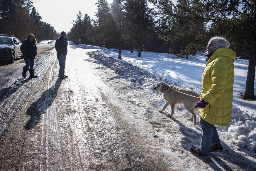 Kristin Kasinskas, left, husband, Peter, and Jeanne Nutter and her dog Henry head back to their homes after speaking with the media Friday, Jan. 11, 2019, in Gordon, Wis. Kristin Kasinskas called 911  ...