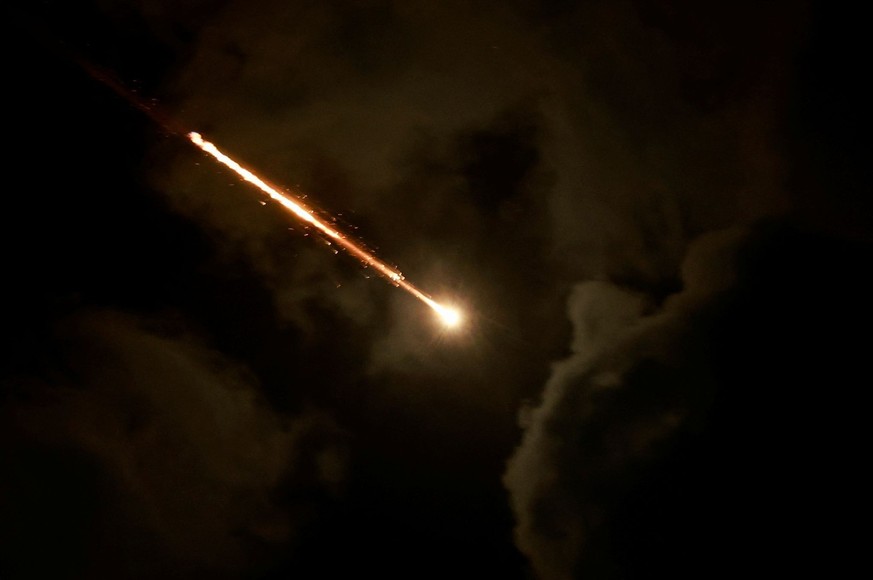 A projectile is seen in the sky after Iran fired a salvo of ballistic missiles, amid cross-border hostilities between Hezbollah and Israel, as seen from Tel Aviv, Israel, October 1, 2024. REUTERS/Amma ...