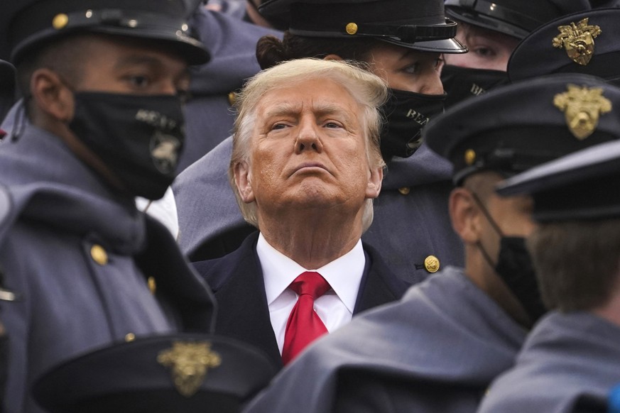 FILE - Surrounded by Army cadets, President Donald Trump watches the first half of the 121st Army-Navy Football Game, Dec. 12, 2020, in West Point, N.Y. When New York&#039;s Adult Survivors Act expire ...