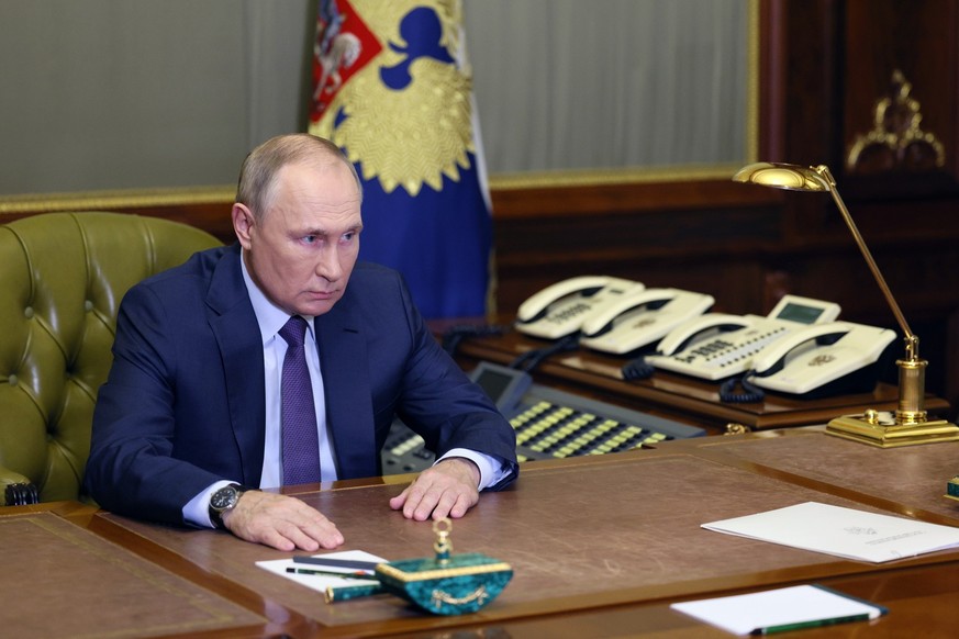 Russian President Vladimir Putin speaks to Investigative Committee Chief Alexander Bastrykin during their meeting in St. Petersburg, Russia, Sunday, Oct. 9, 2022. (Gavriil Grigorov, Sputnik, Kremlin P ...