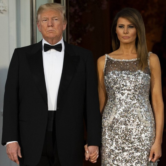 United States President Donald J. Trump and first lady of the United States Melania Trump emerge from the White House as the await the arrival of French President Emmanuel Macron and first lady of Fra ...