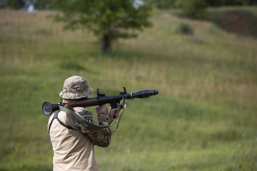 Photo dated June 23, 2022 showing Azov Army fighters moving RPG anti-tank rockets during training, outside Kharkiv, Ukraine issued 24 June 2022. For the Ukrainians they are national heroes, for the Ru ...