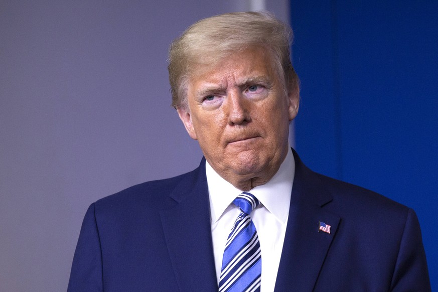 United States President Donald J. Trump listens as United States Vice President Mike Pence delivers remarks on the Coronavirus pandemic during a news conference in the James S. Brady Press Briefing ro ...