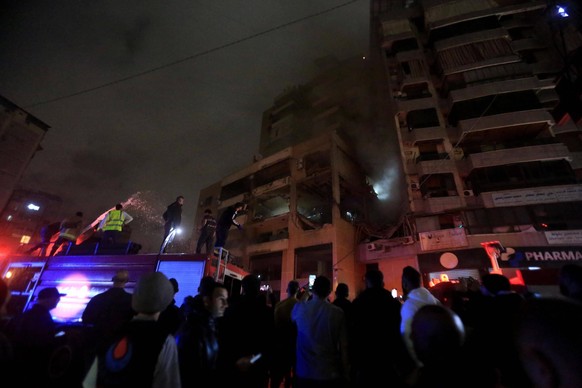 240102 -- BEIRUT, Jan. 2, 2024 -- People gather outside an apartment belonging to the Hamas movement destroyed by an Israeli attack on the southern suburb of Beirut, Lebanon, on Jan. 2, 2024. A Hamas  ...