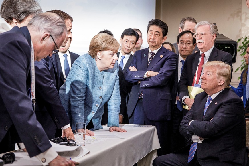 German Chancellor Angela Merkel speaks to U.S. President Donald Trump during the second day of the G7 meeting in Charlevoix city of La Malbaie, Quebec, Canada, June 9, 2018. Bundesregierung/Jesco Denz ...